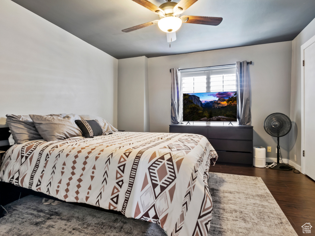 Bedroom with dark hardwood / wood-style flooring and ceiling fan
