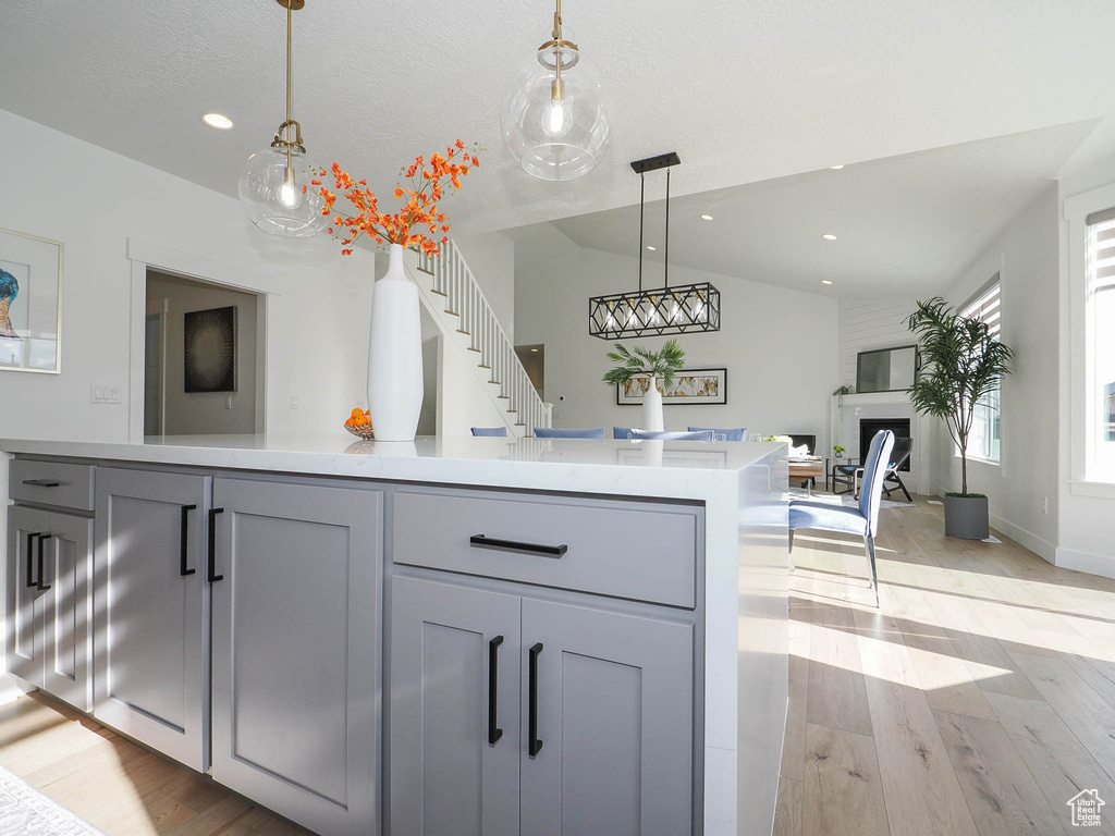Kitchen featuring pendant lighting, gray cabinets, and light wood-type flooring