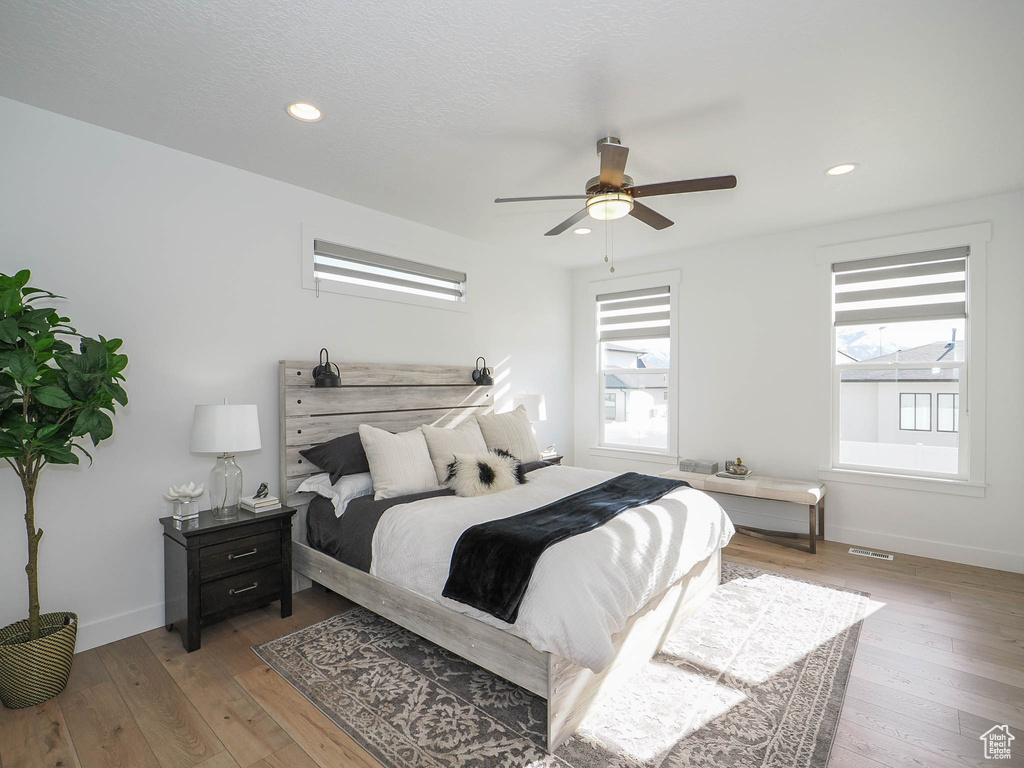 Bedroom featuring ceiling fan and wood-type flooring