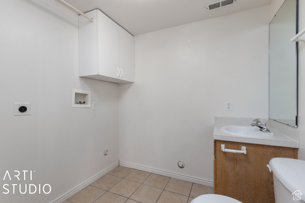 Interior space with tile floors, toilet, and vanity
