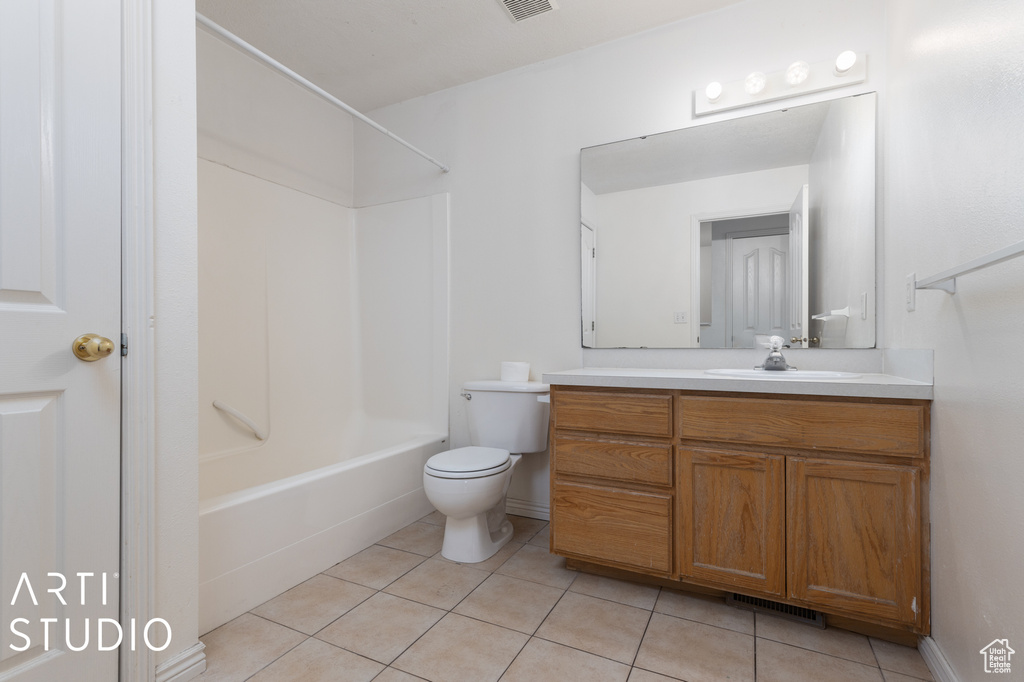 Full bathroom featuring  shower combination, tile flooring, toilet, and large vanity