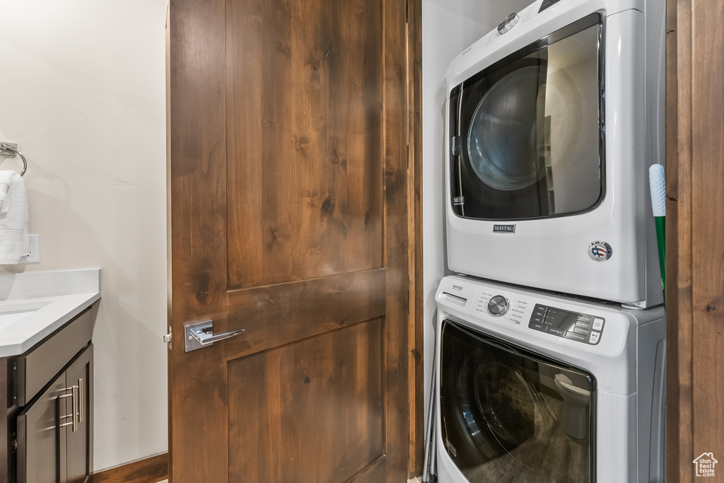 Clothes washing area with stacked washer and clothes dryer