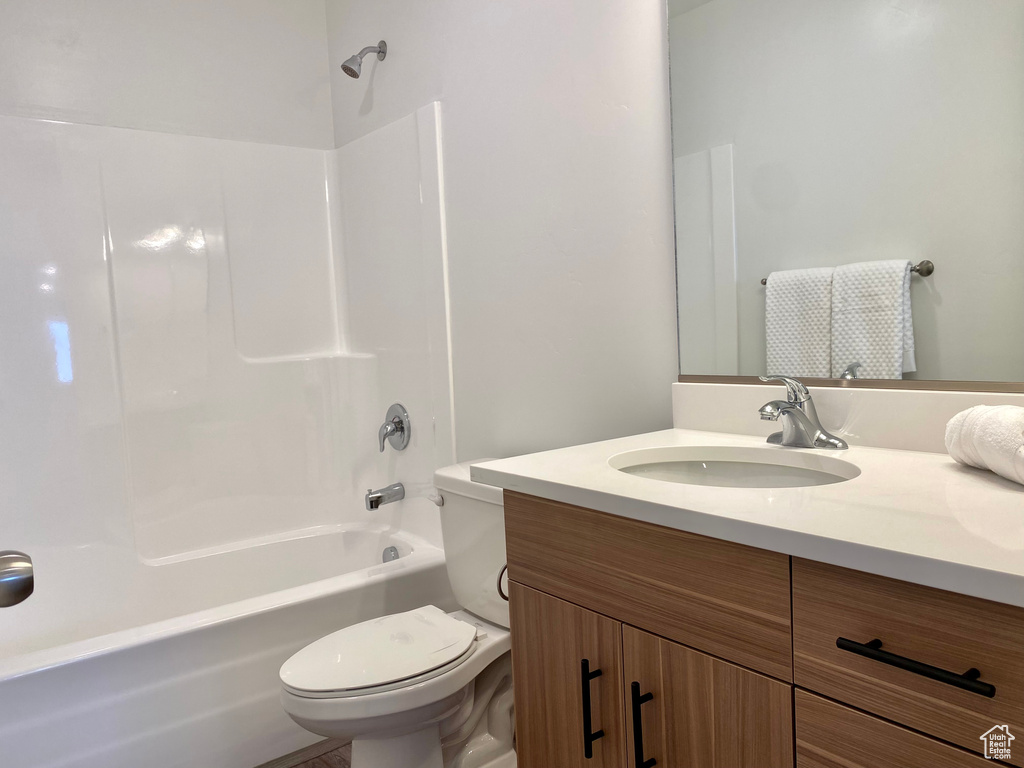 Full bathroom featuring toilet, vanity, and shower / tub combination