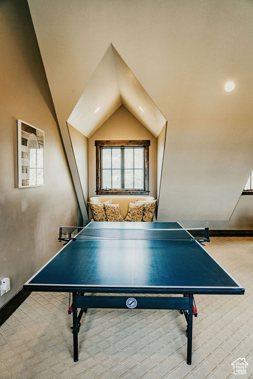 Recreation room featuring lofted ceiling and light carpet