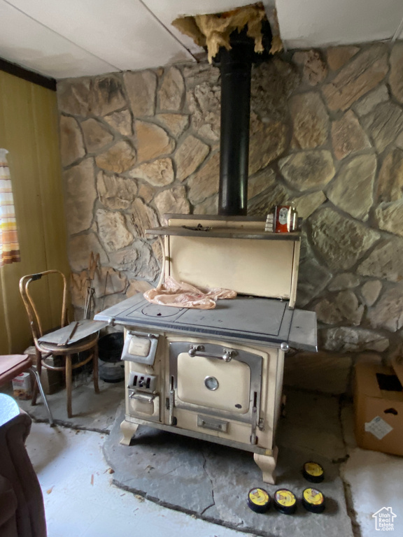 Interior details featuring concrete floors and a wood stove