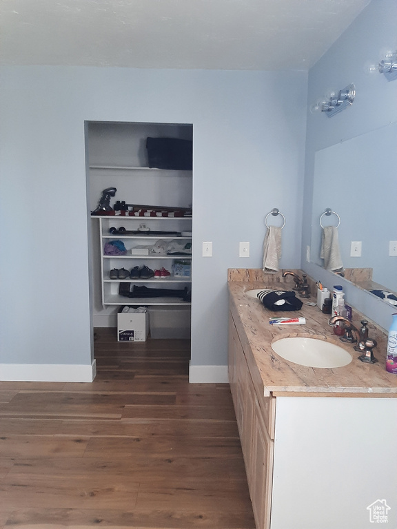 Bathroom with hardwood / wood-style floors and double sink vanity