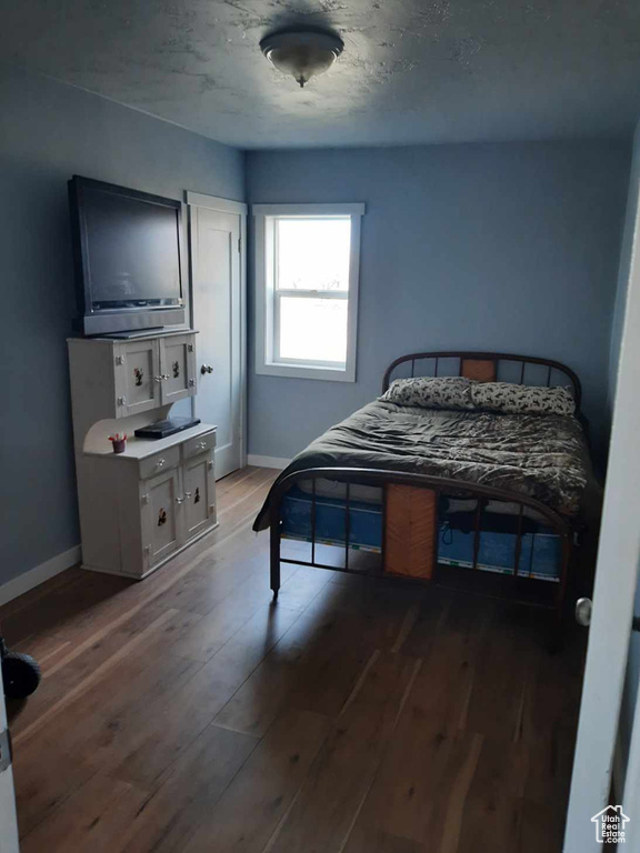 Bedroom featuring dark hardwood / wood-style flooring