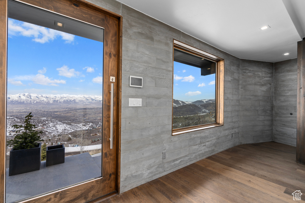 Spare room featuring dark hardwood / wood-style flooring and a mountain view