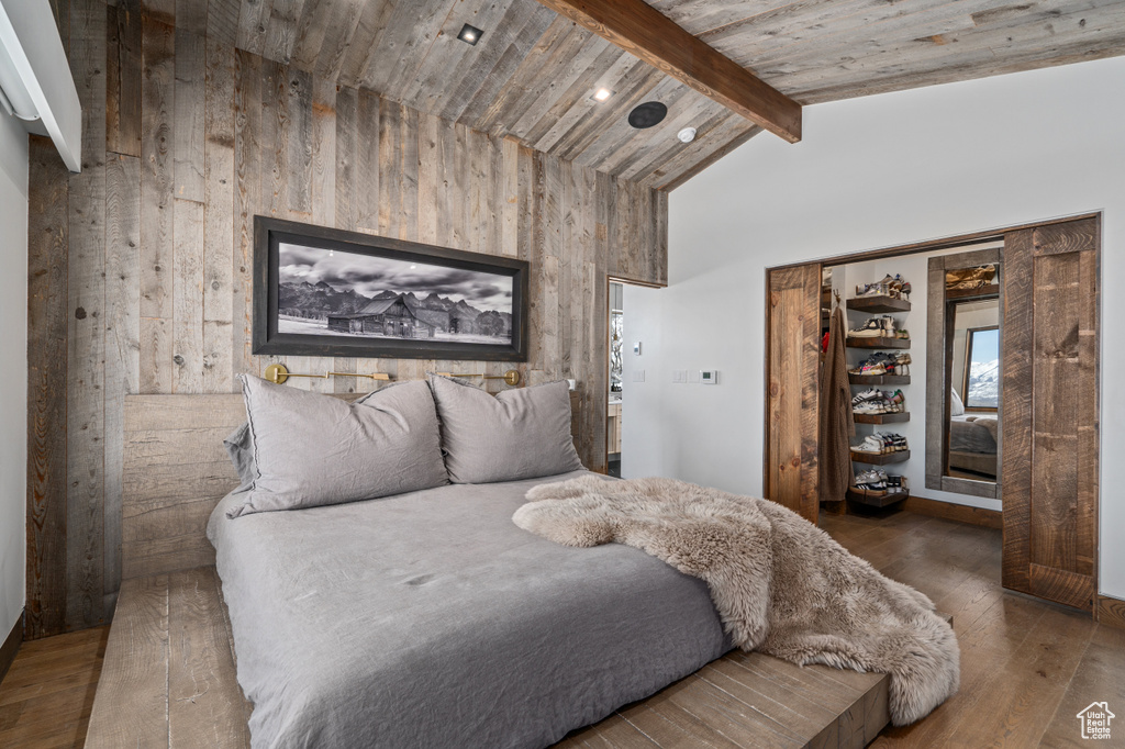 Bedroom with high vaulted ceiling, dark hardwood / wood-style floors, wood ceiling, and beamed ceiling