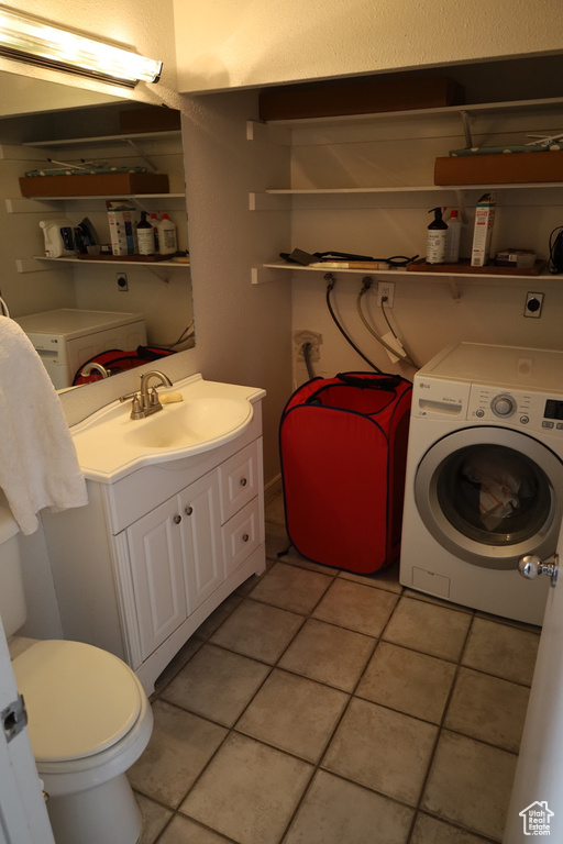 Interior space featuring washer hookup, light tile floors, separate washer and dryer, hookup for an electric dryer, and sink