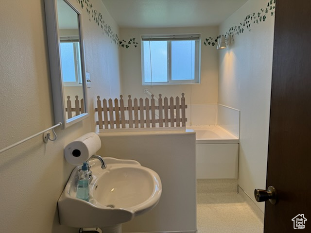 Bathroom with a healthy amount of sunlight and sink