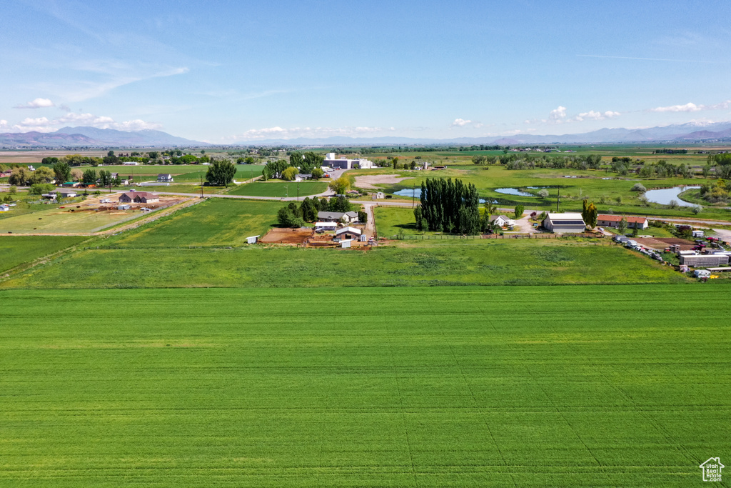 Birds eye view of property featuring a water and mountain view and a rural view