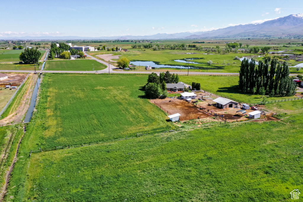 Birds eye view of property featuring a water and mountain view and a rural view