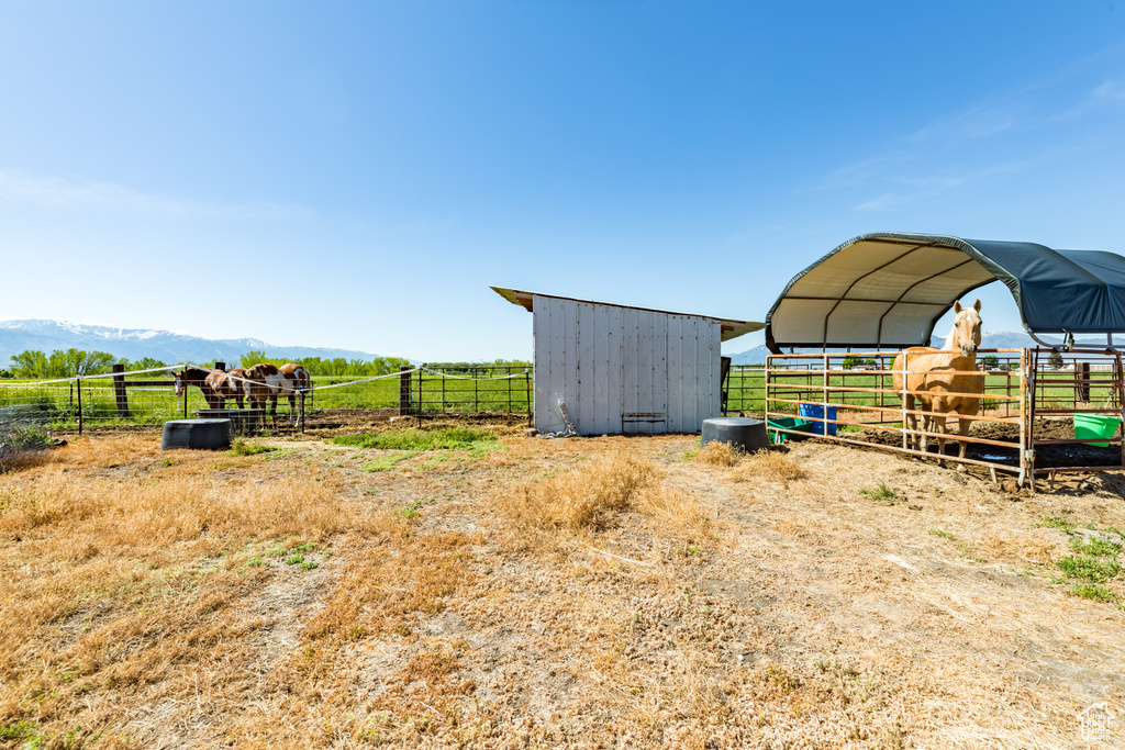 View of yard featuring an outdoor structure and a rural view