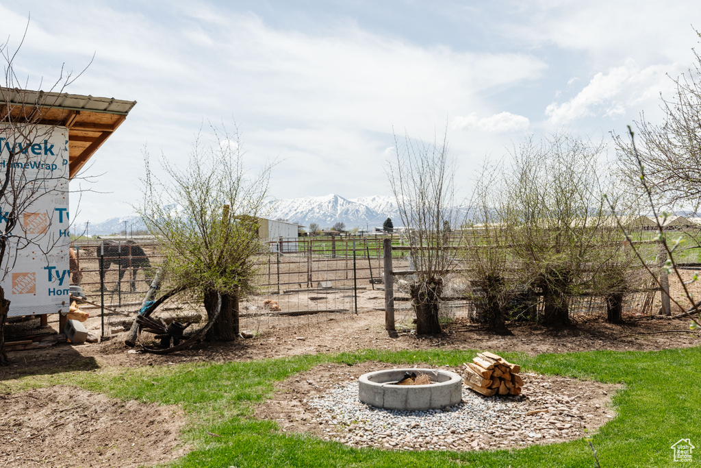 View of yard with a fire pit and a mountain view