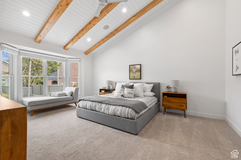 Bedroom featuring light colored carpet, beamed ceiling, and high vaulted ceiling