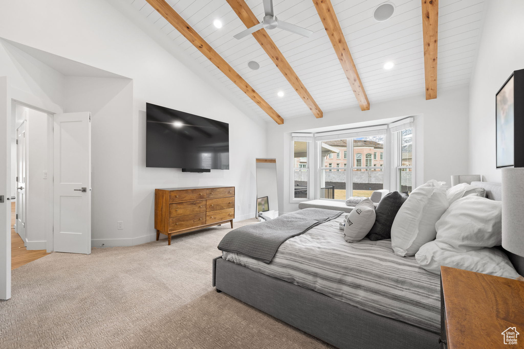 Bedroom featuring ceiling fan, high vaulted ceiling, light carpet, and beamed ceiling