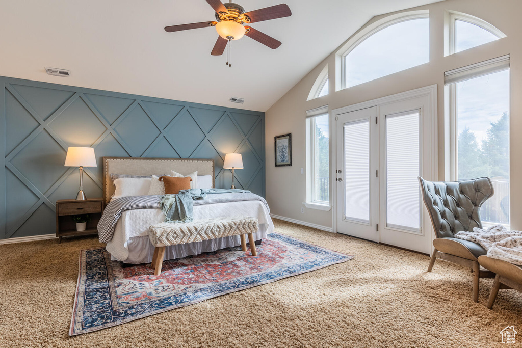 Bedroom with ceiling fan, access to outside, light colored carpet, and vaulted ceiling
