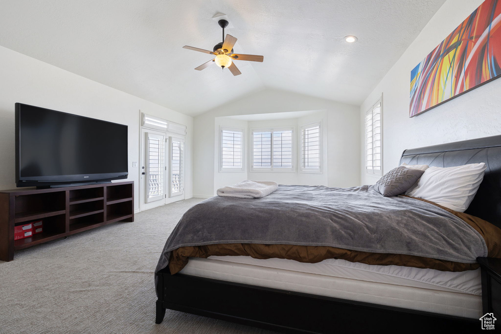 Bedroom with ceiling fan, lofted ceiling, light carpet, and access to exterior