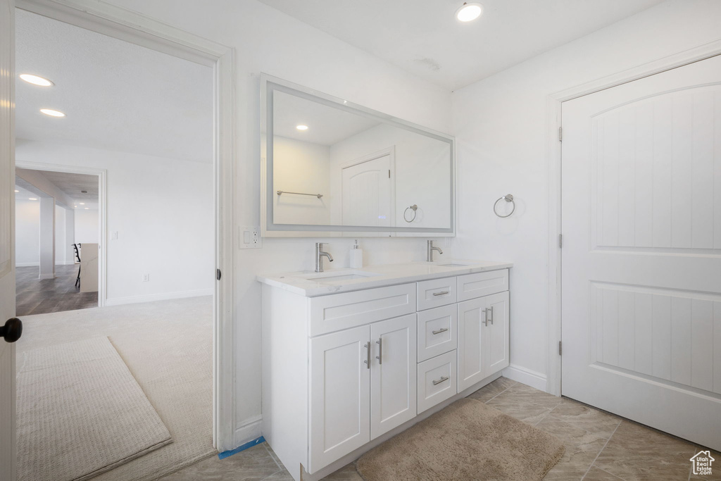 Bathroom with dual bowl vanity and tile flooring