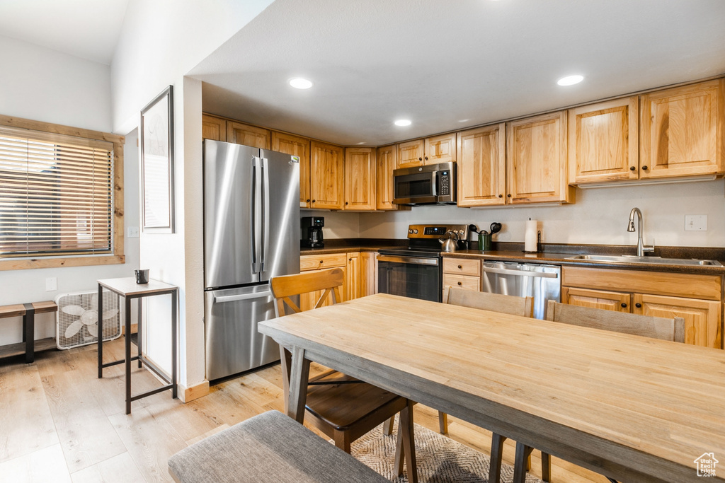 Kitchen featuring light hardwood / wood-style flooring, sink, light brown cabinetry, and stainless steel appliances