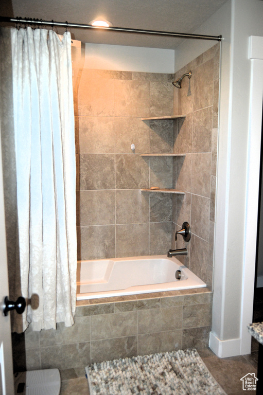 Bathroom with shower / tub combo and tile floors