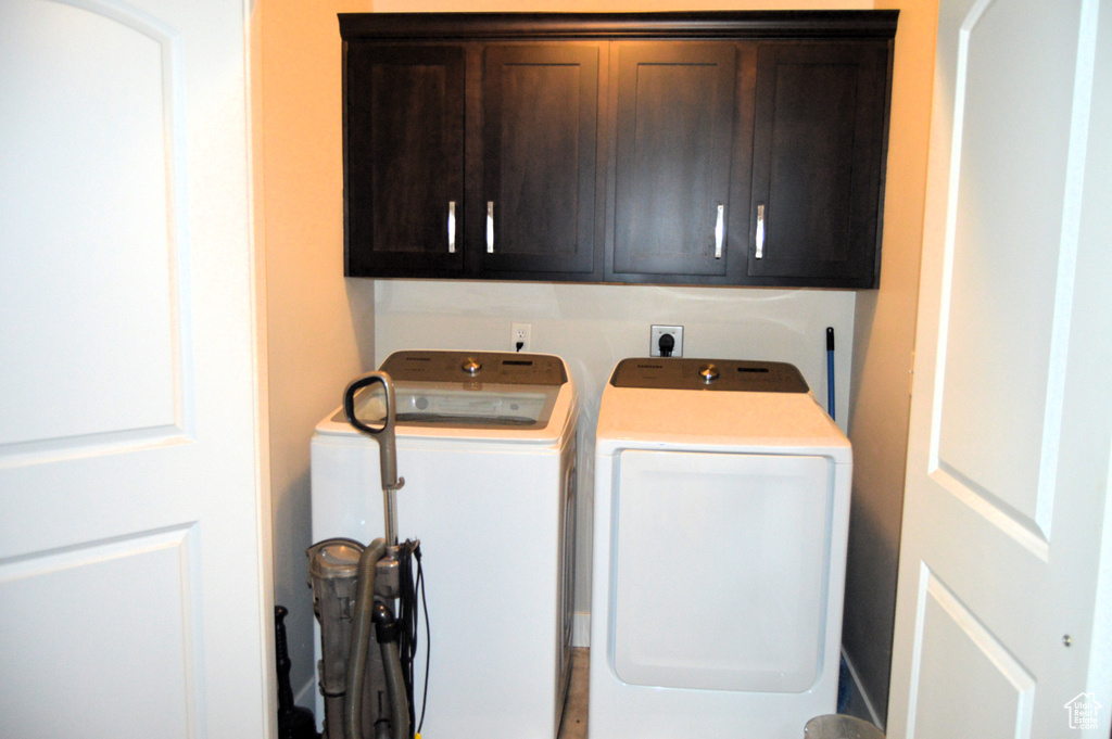 Laundry room with cabinets, washer and dryer, and hookup for an electric dryer
