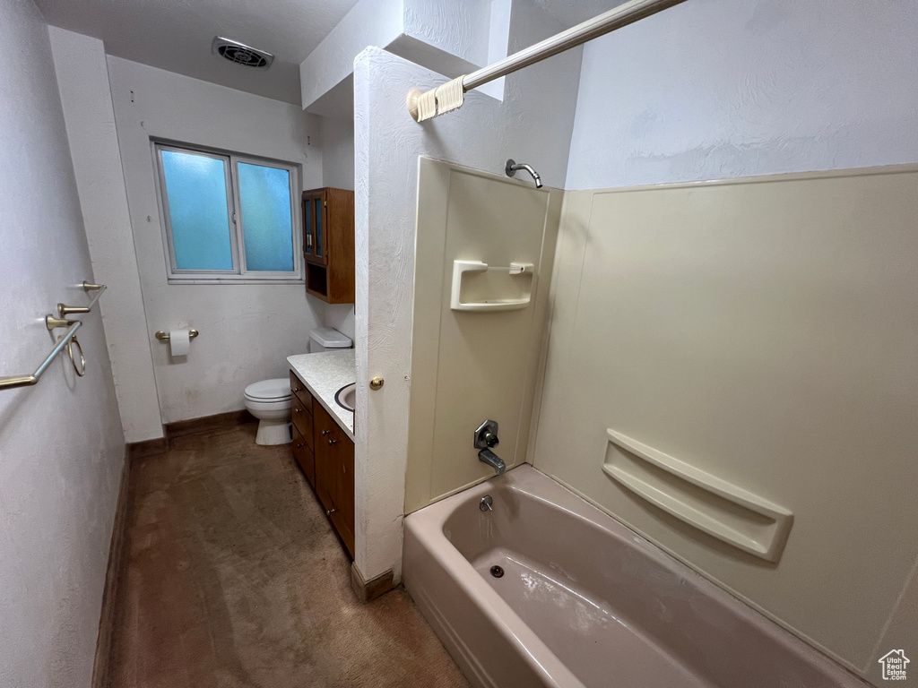 Full bathroom featuring bathing tub / shower combination, toilet, and vanity