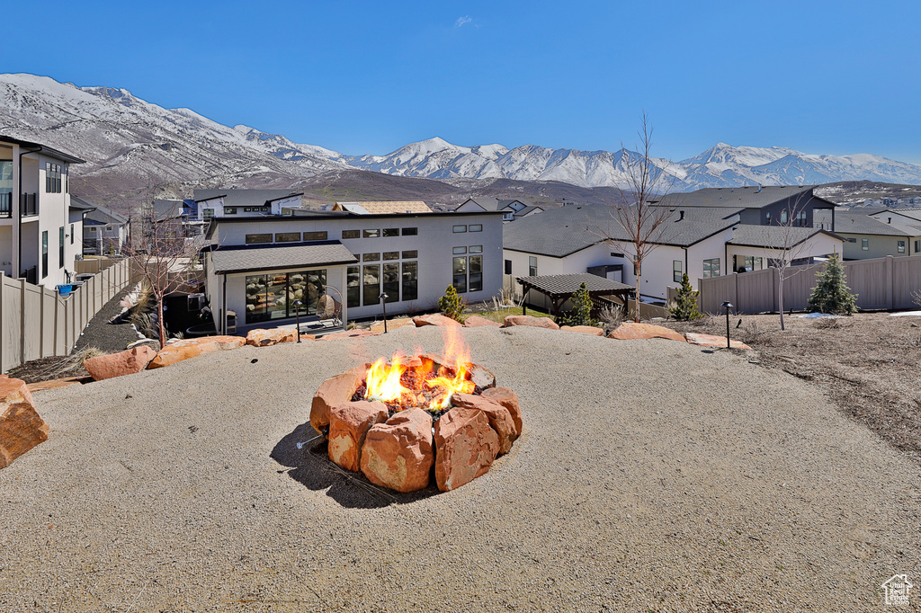 View of front of home featuring an outdoor fire pit and a mountain view