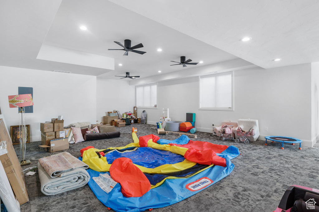 Playroom with ceiling fan and carpet floors