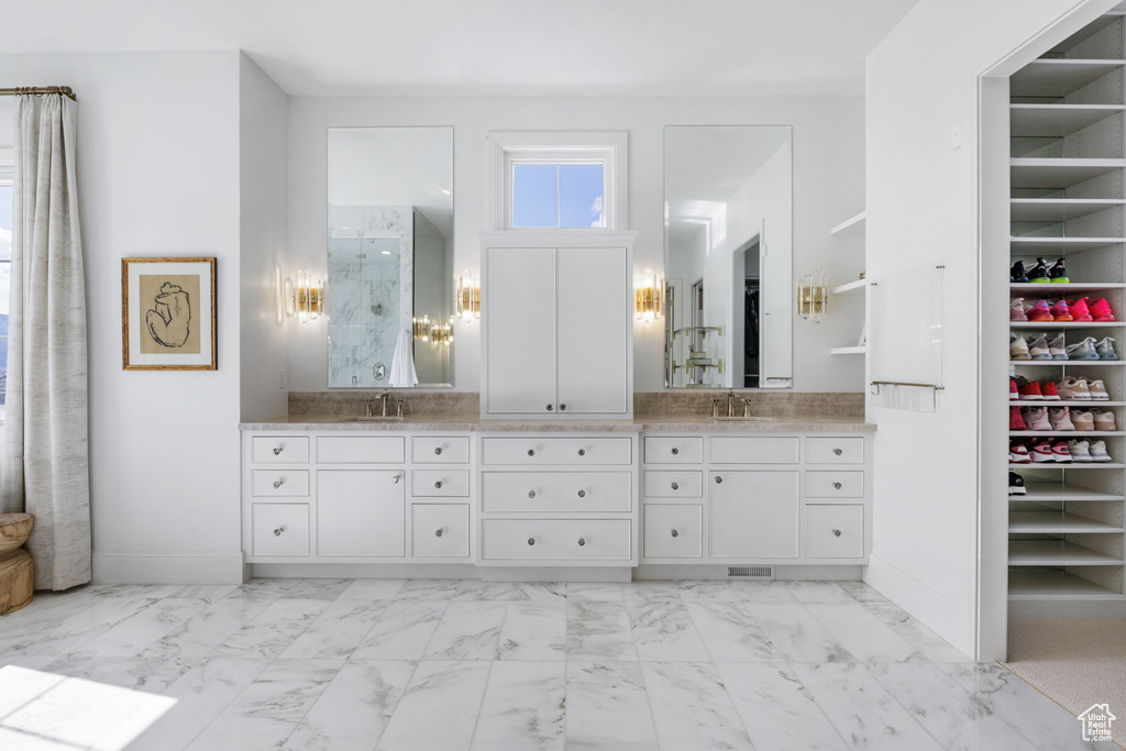 Bathroom with tile floors, double sink, and oversized vanity