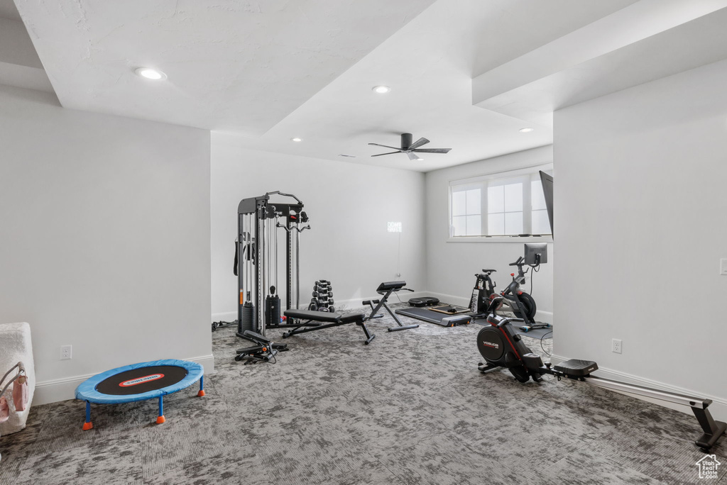 Workout room featuring ceiling fan and carpet floors