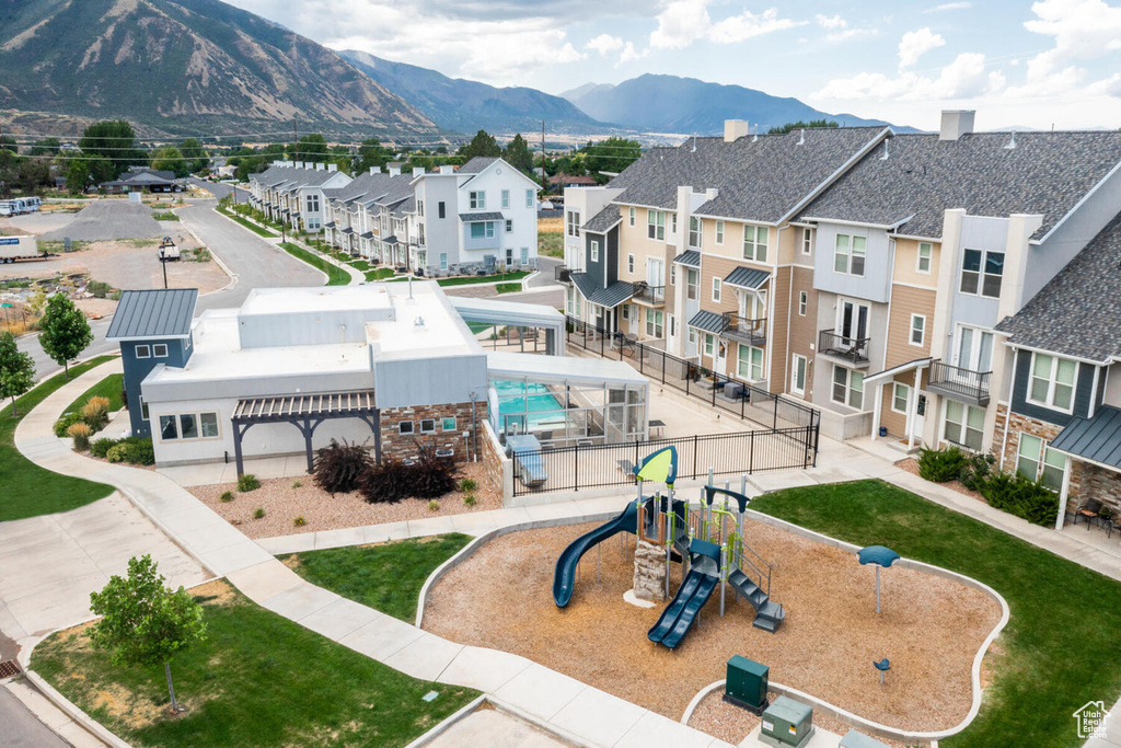 Exterior space with a playground and a mountain view