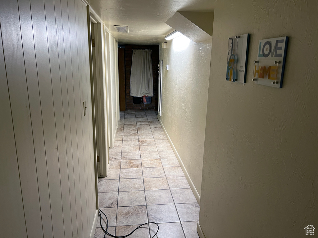 Hallway with light tile flooring