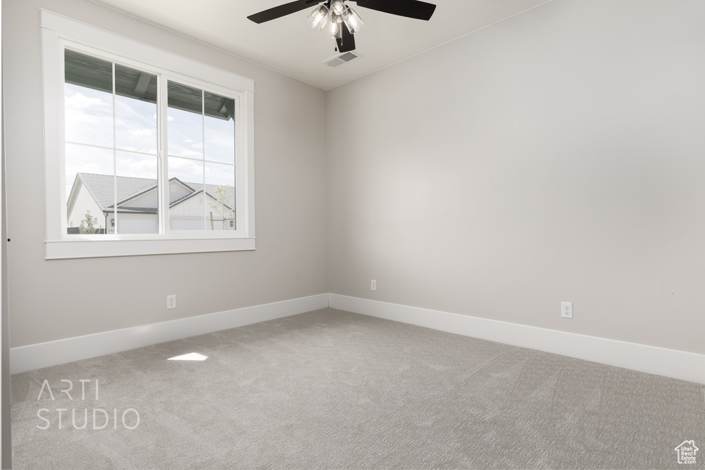 Spare room with carpet flooring and ceiling fan