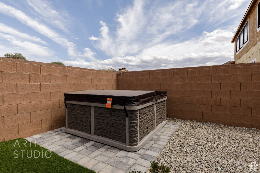 Exterior space with a hot tub