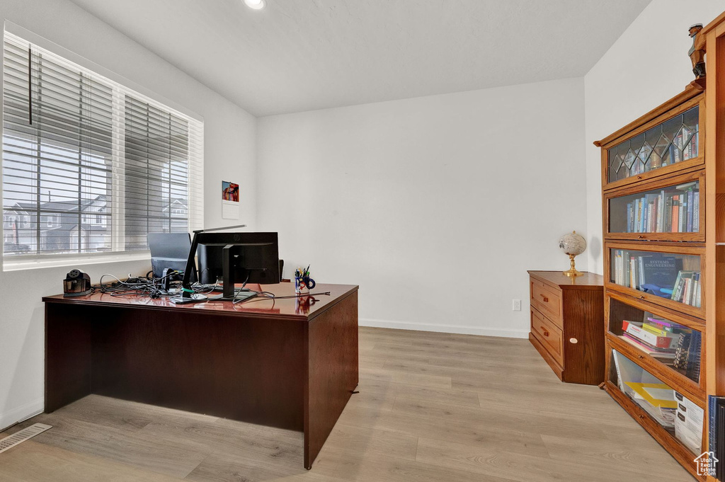 Home office with light hardwood / wood-style floors