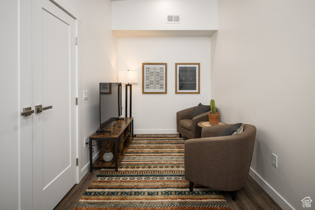 Living area with dark hardwood / wood-style flooring