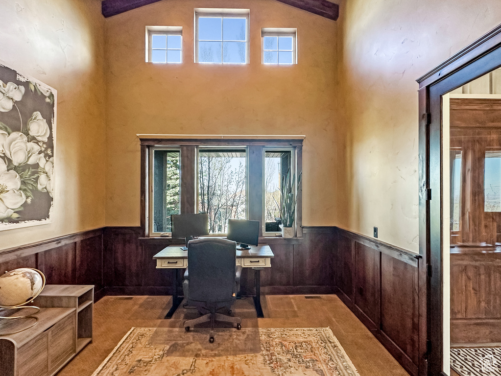 Office featuring built in desk, high vaulted ceiling, and beamed ceiling