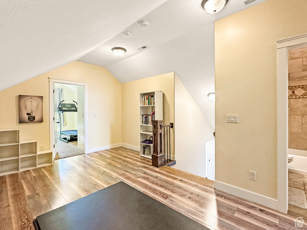 Bonus room featuring lofted ceiling and light hardwood / wood-style floors