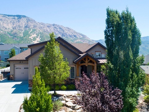 Craftsman inspired home with a garage and a mountain view