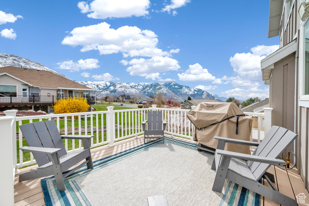 Deck featuring a lawn and a mountain view