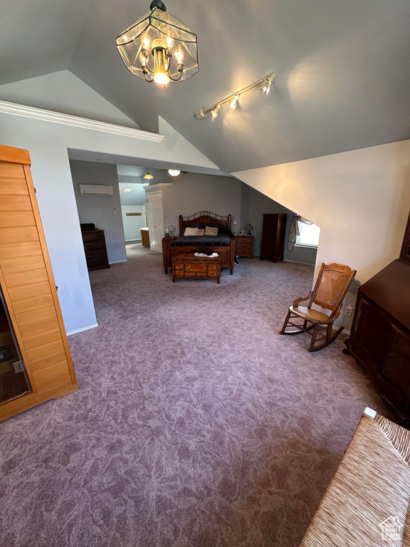 Carpeted bedroom with a notable chandelier, track lighting, vaulted ceiling, and a wall unit AC