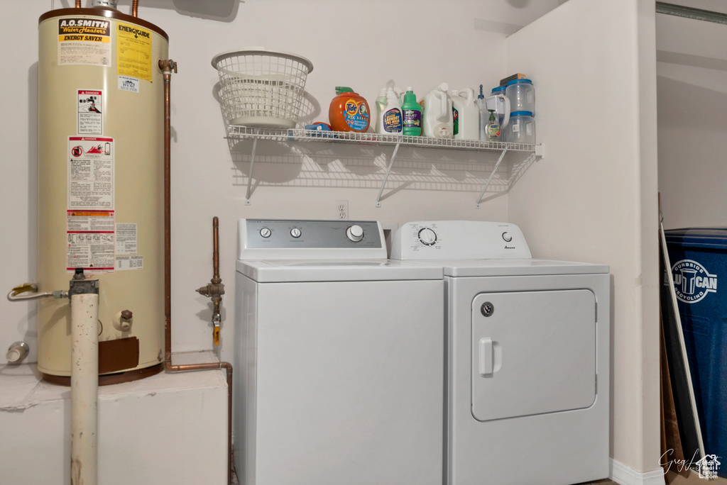 Laundry area featuring washer and dryer and water heater