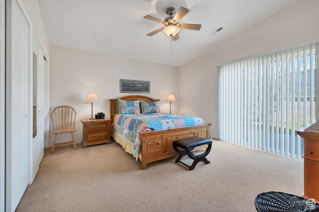 Carpeted bedroom with a closet, access to exterior, ceiling fan, and vaulted ceiling