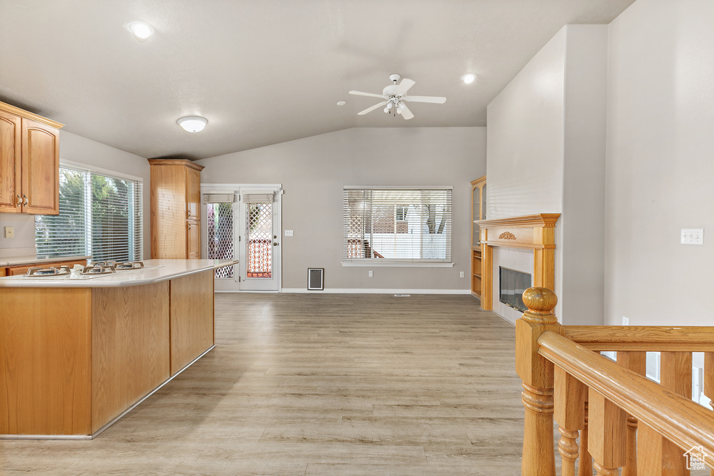 Kitchen featuring ceiling fan, lofted ceiling, and light hardwood / wood-style flooring