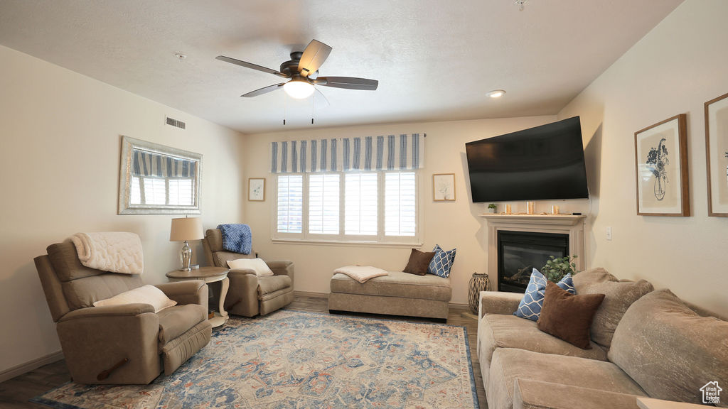 Living room featuring ceiling fan and hardwood / wood-style floors