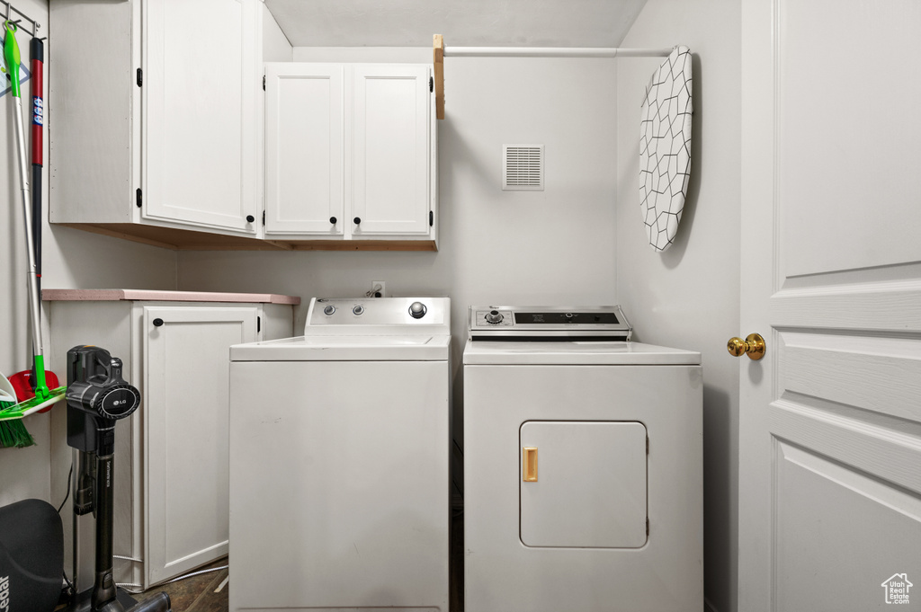 Laundry room with cabinets and separate washer and dryer