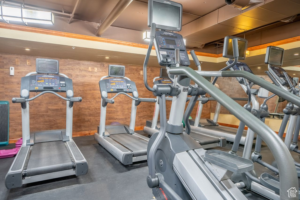 Workout area featuring wood walls