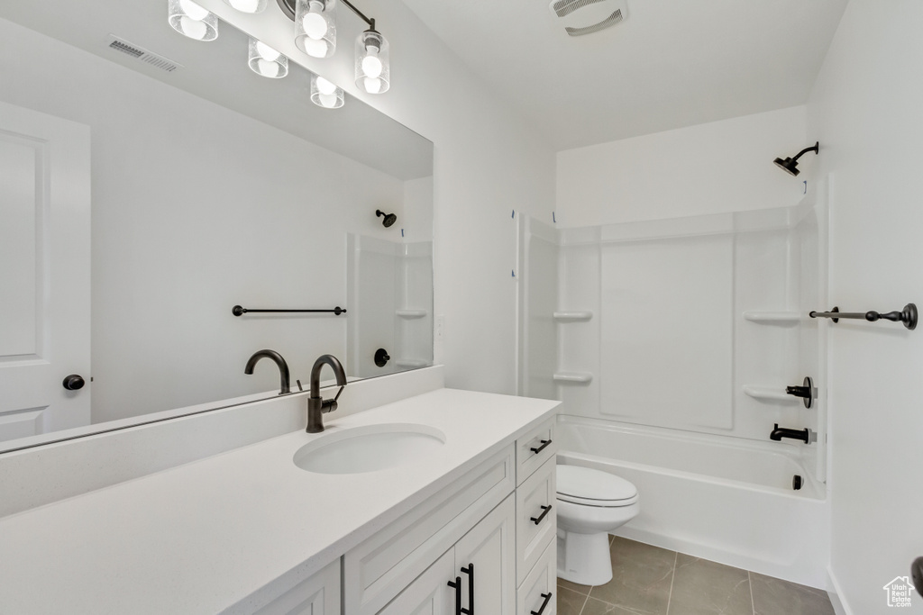 Full bathroom with toilet, oversized vanity, tile flooring, and bathing tub / shower combination